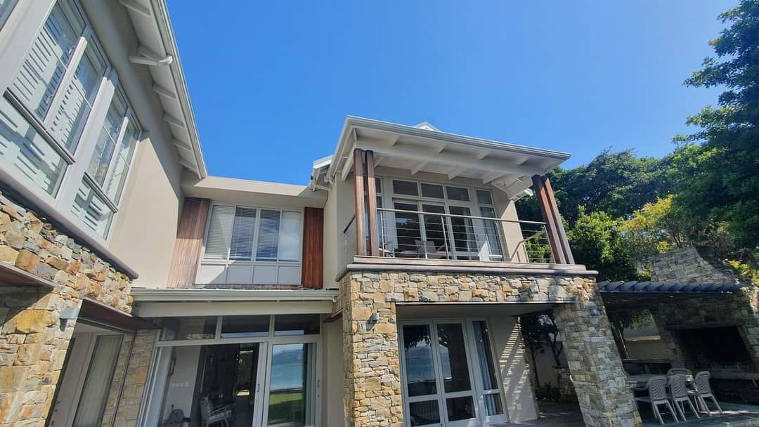 Completed coastal home with stone facade and timber accents