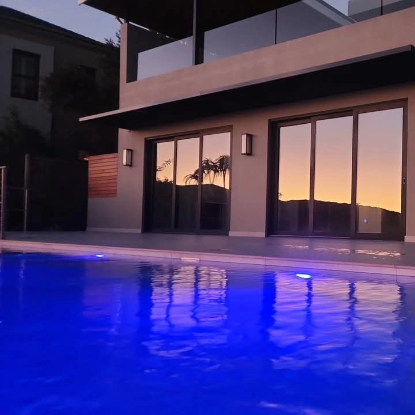Modern poolside elevation at sunset
