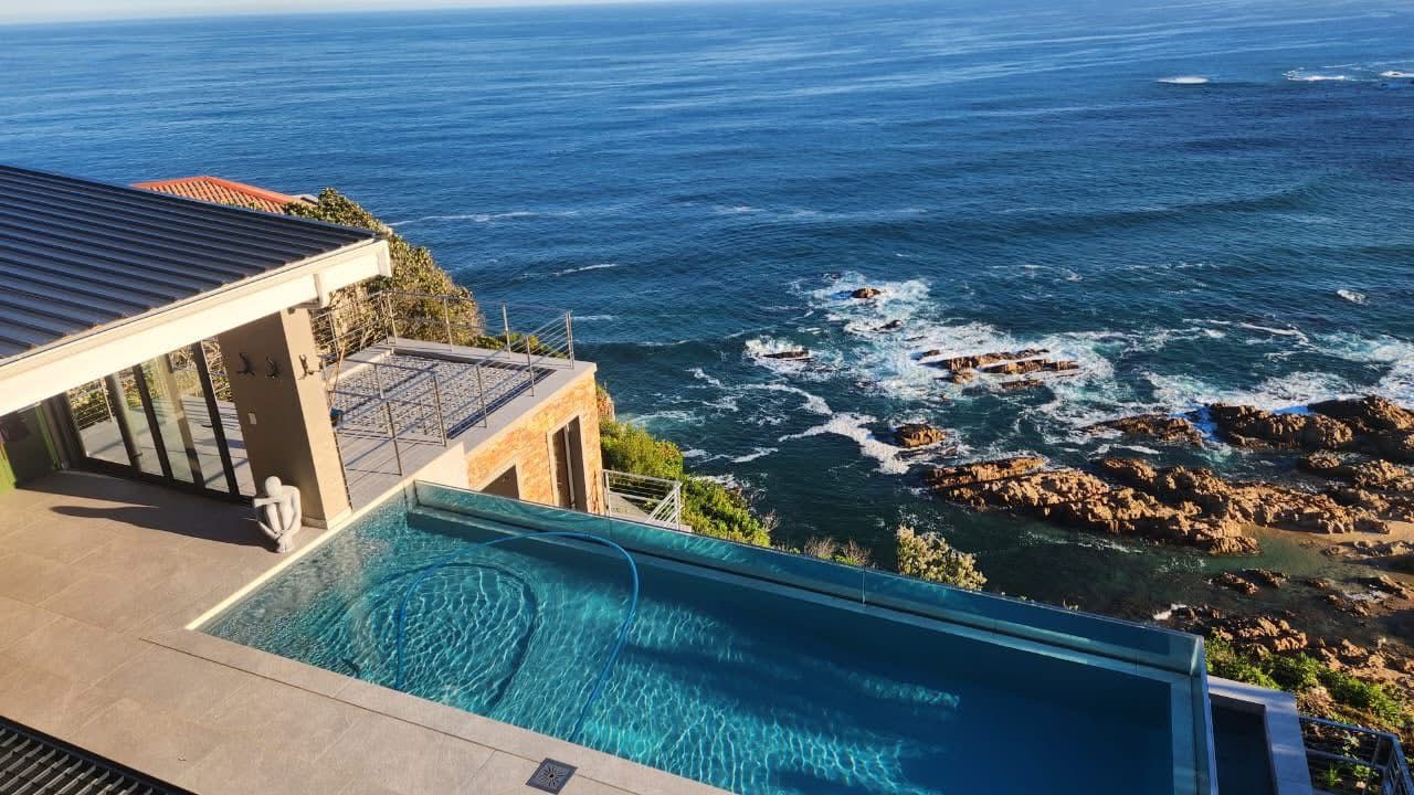 Cliffside infinity pool overlooking the rocky Garden Route coastline