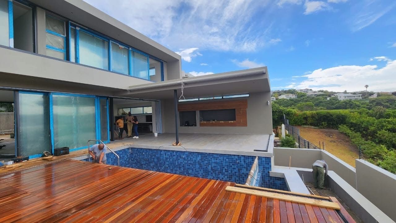 Modern home with mosaic-tiled pool and freshly oiled hardwood deck